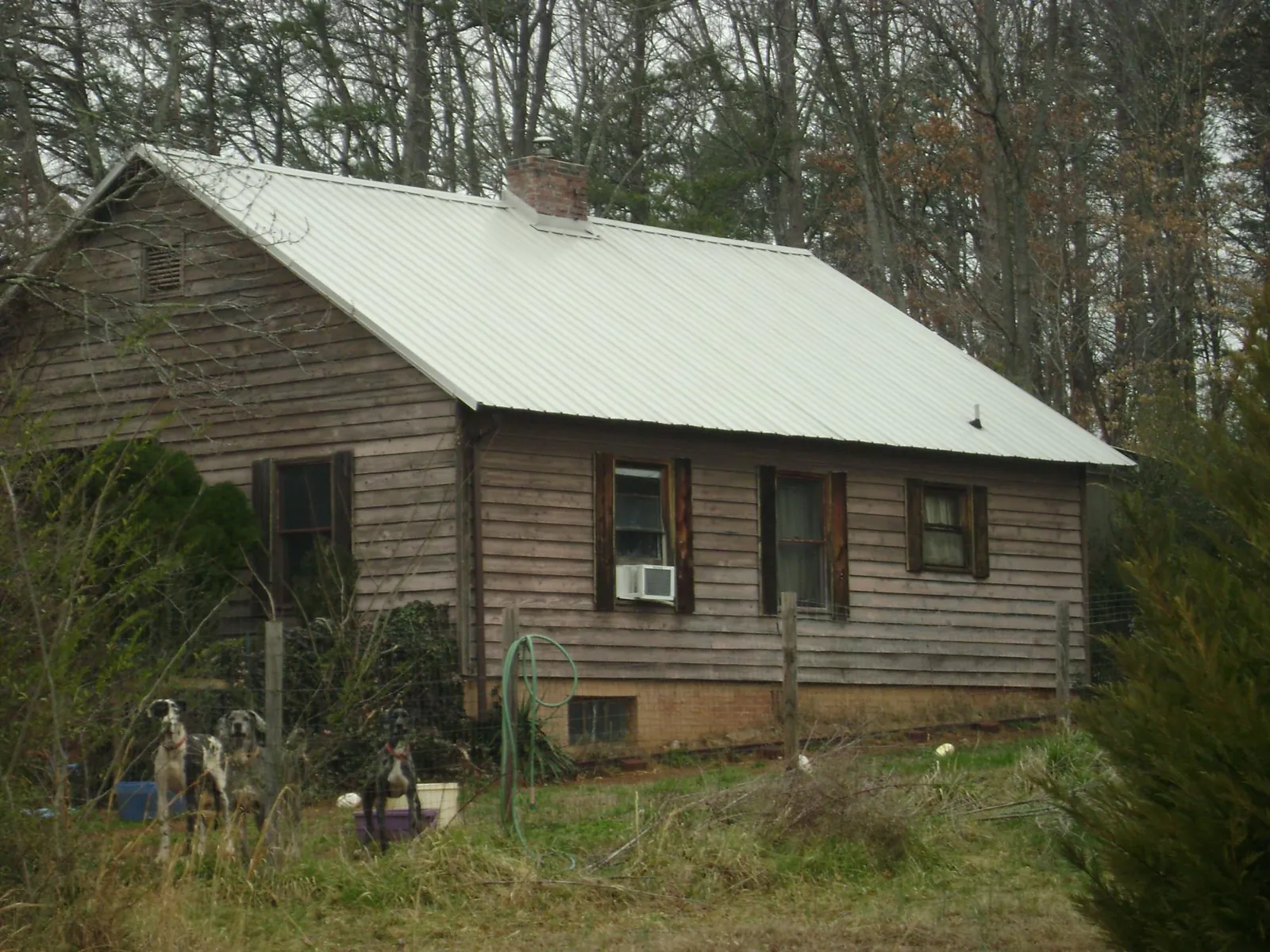 White metal roof on an old wood sided farmhouse, from a Metal Roof Installation job in Wheeler